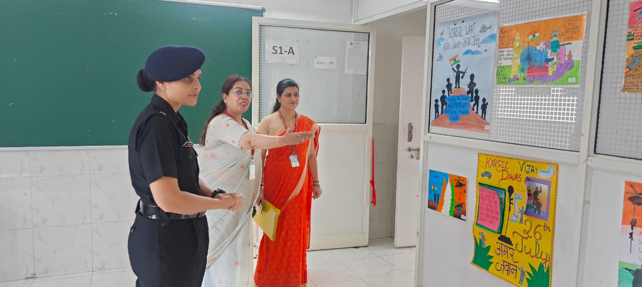 Faculty guides Lt. Col. Rathore through the poster exhibition.